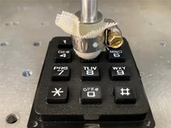 Test fabric clamped to Real Touch™ Finger Probe testing keypad